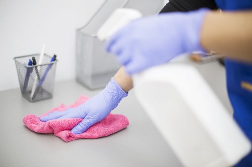 Cleaner preparing carpet cleaning equipment with safety measures in place